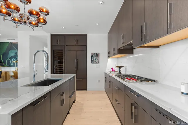 a kitchen with granite countertop a sink stainless steel appliances and cabinets
