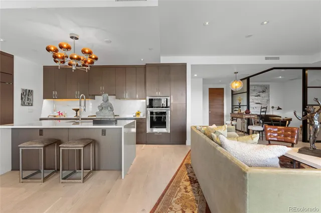 a kitchen with granite countertop a sink stove and cabinets