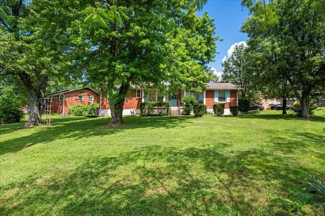 a view of house with yard