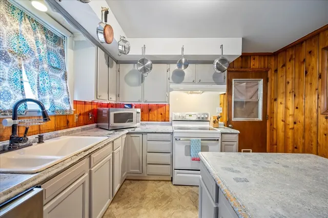 a kitchen with a sink stove and refrigerator