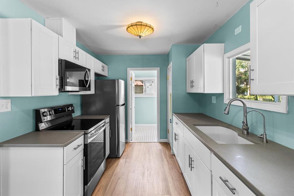 7 65th Street Yankeetown, FL 34498 - Photo 11 of 43 a kitchen with a sink stove and cabinets