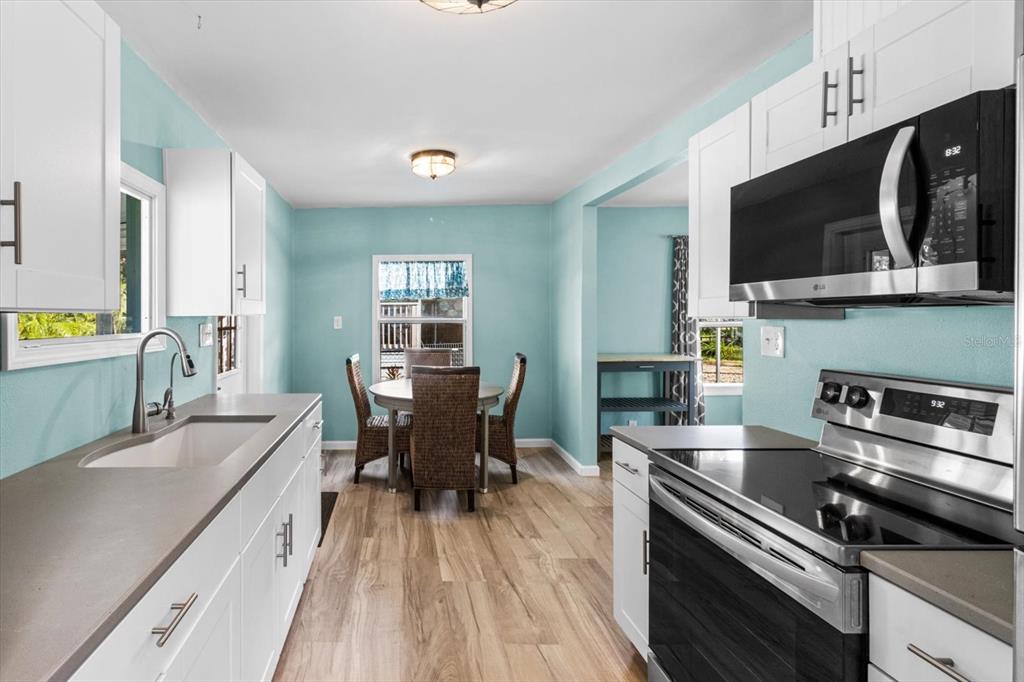 7 65th Street Yankeetown, FL 34498 - Photo 12 of 43 a kitchen with a stove a sink and a microwave