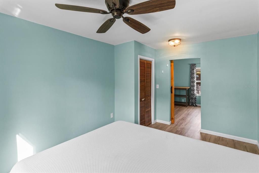 7 65th Street Yankeetown, FL 34498 - Photo 16 of 43 a bedroom with a bed and a chandelier