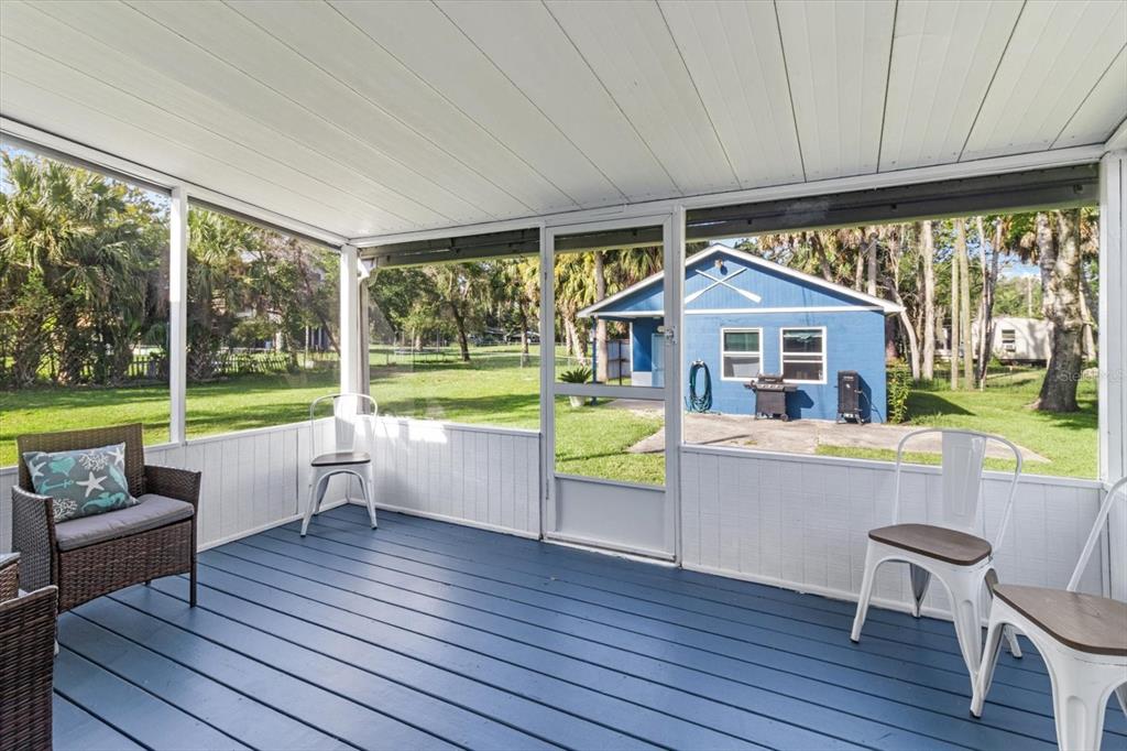 7 65th Street Yankeetown, FL 34498 - Photo 18 of 43 a view of living room kitchen with furniture and floor to ceiling window