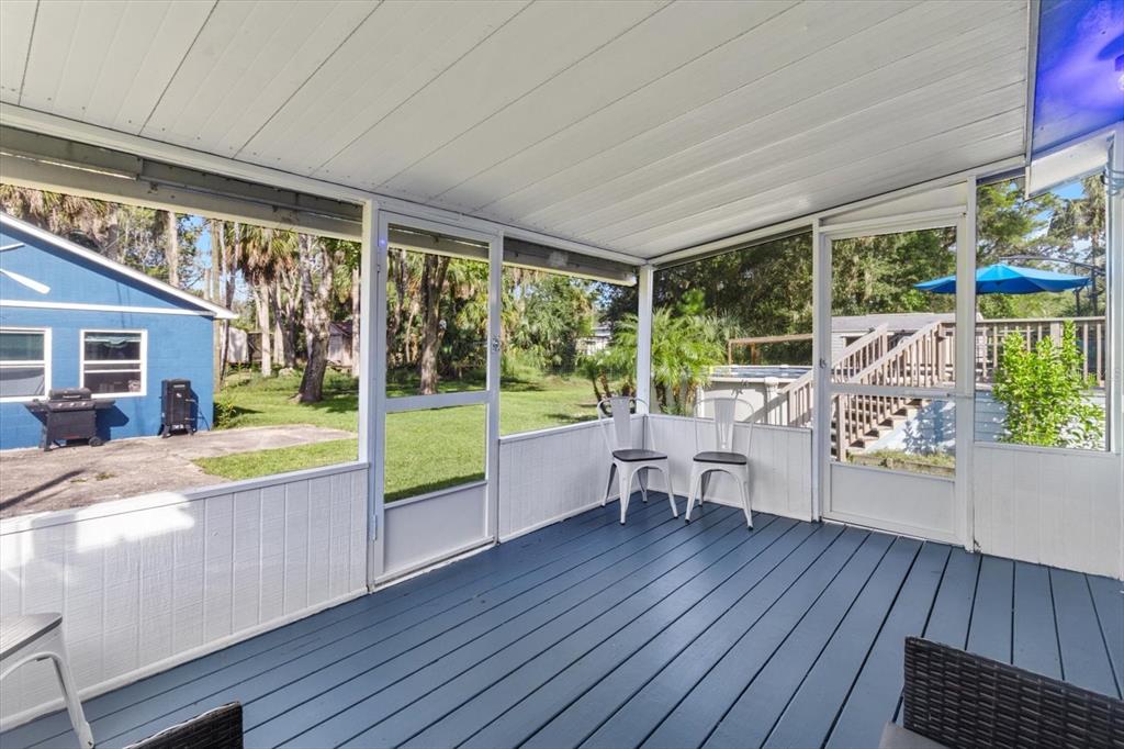 7 65th Street Yankeetown, FL 34498 - Photo 19 of 43 a view of a patio with a table chairs and wooden floor