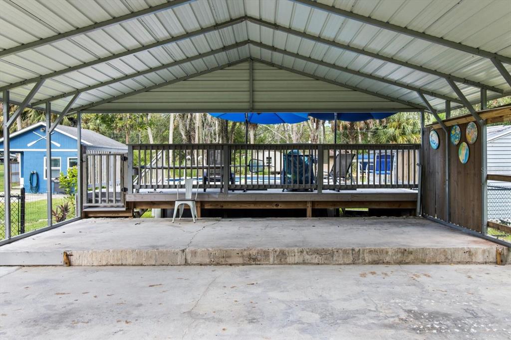 7 65th Street Yankeetown, FL 34498 - Photo 25 of 43 a view of a porch with a bench under an umbrella