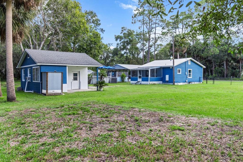 7 65th Street Yankeetown, FL 34498 - Photo 30 of 43 a view of a house with a yard and large trees