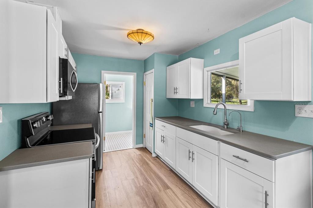 7 65th Street Yankeetown, FL 34498 - Photo 10 of 43 a kitchen with a sink a stove and cabinets