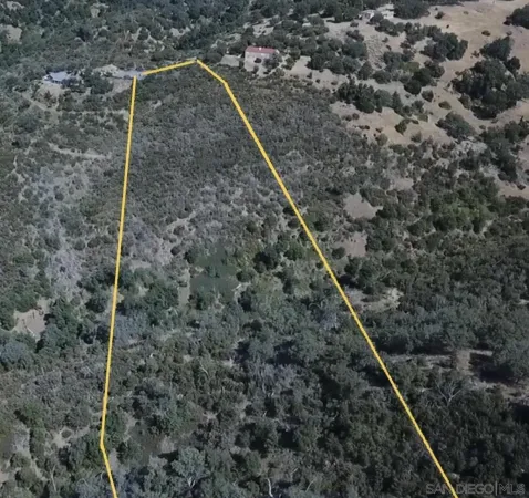 a backyard of a house with a small barn