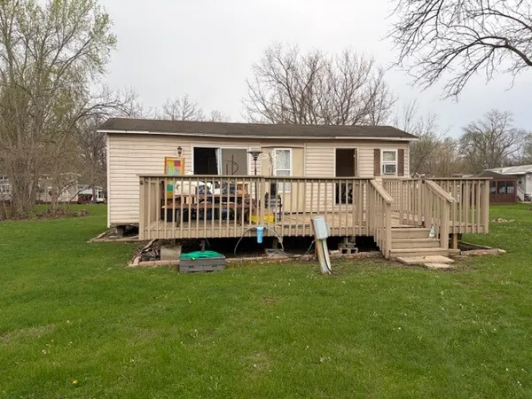 a view of a house with a yard and deck