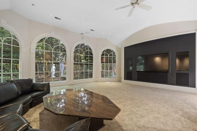 1120 Heards Ferry Road Northwest Sandy Springs, GA 30328 - Photo 17 of 50 a living room with furniture and a flat screen tv