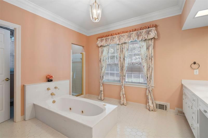 1120 Heards Ferry Road Northwest Sandy Springs, GA 30328 - Photo 20 of 50 a bathroom with a bathtub and a shower