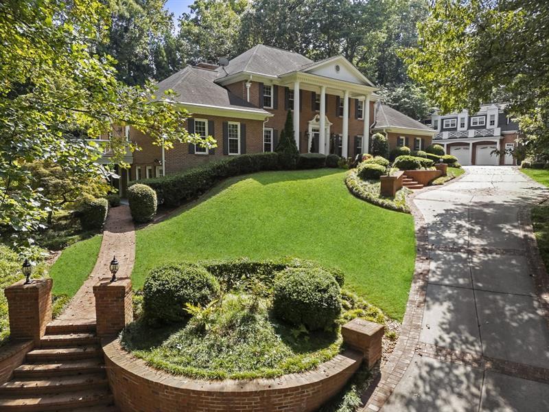 1120 Heards Ferry Road Northwest Sandy Springs, GA 30328 - Photo 2 of 50 a front view of a house with a yard table and chairs