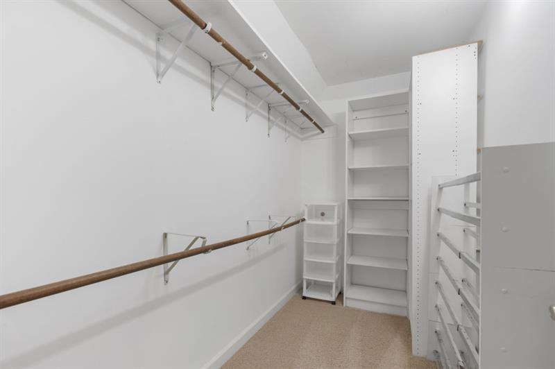 1120 Heards Ferry Road Northwest Sandy Springs, GA 30328 - Photo 24 of 50 a view of walk in closet with empty racks