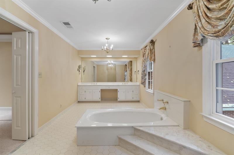 1120 Heards Ferry Road Northwest Sandy Springs, GA 30328 - Photo 27 of 50 a large white kitchen with a tub and painted walls