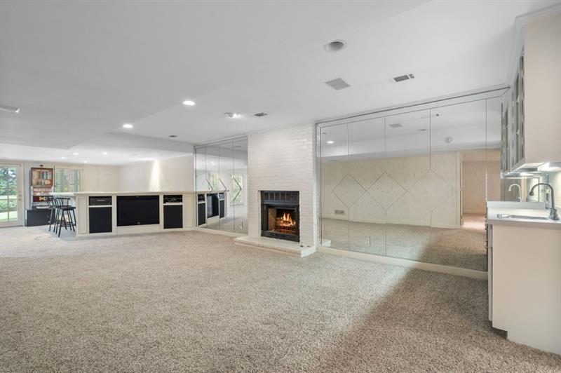 1120 Heards Ferry Road Northwest Sandy Springs, GA 30328 - Photo 33 of 50 a view of a big room with windows and fireplace