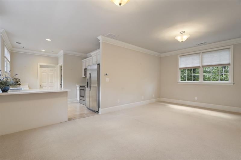 1120 Heards Ferry Road Northwest Sandy Springs, GA 30328 - Photo 37 of 50 an empty room with a window and a kitchen