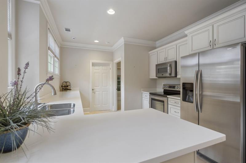 1120 Heards Ferry Road Northwest Sandy Springs, GA 30328 - Photo 38 of 50 a kitchen with kitchen island a counter top space stainless steel appliances and cabinets