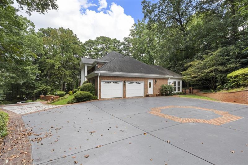 1120 Heards Ferry Road Northwest Sandy Springs, GA 30328 - Photo 41 of 50 a front view of a house with a yard and garage