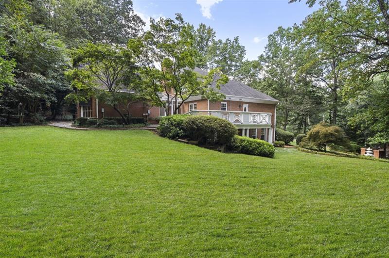 1120 Heards Ferry Road Northwest Sandy Springs, GA 30328 - Photo 46 of 50 a front view of a house with a garden