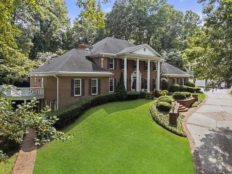 1120 Heards Ferry Road Northwest Sandy Springs, GA 30328 - Photo 49 of 50 a front view of a house with a garden and porch