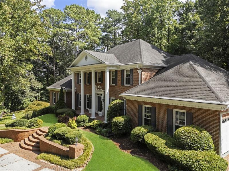 1120 Heards Ferry Road Northwest Sandy Springs, GA 30328 - Photo 50 of 50 a front view of a house with a yard and porch