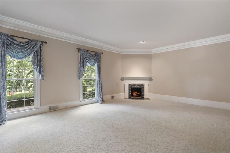 1120 Heards Ferry Road Northwest Sandy Springs, GA 30328 - Photo 5 of 50 a view of an empty room with a fireplace and a window