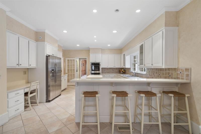 1120 Heards Ferry Road Northwest Sandy Springs, GA 30328 - Photo 9 of 50 a kitchen with stainless steel appliances granite countertop a sink and a refrigerator