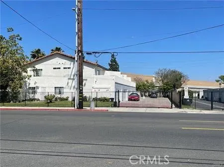 a building with a street light and a car parked on road