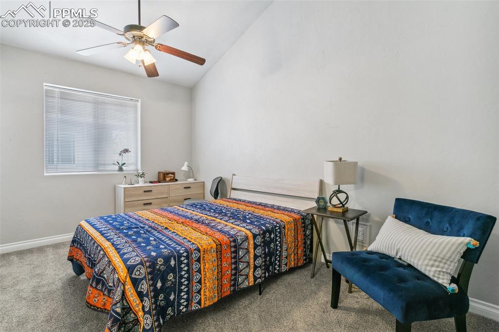 1502 York Road, Unit 103 Colorado Springs, CO 80920 - Photo 17 of 27 a bedroom with a bed and a chandelier