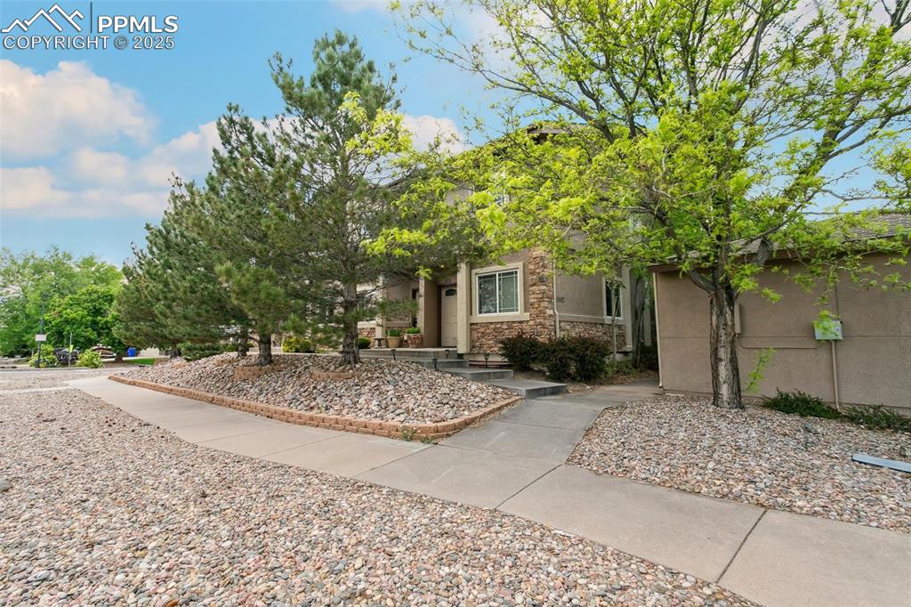 1502 York Road, Unit 103 Colorado Springs, CO 80920 - Photo 2 of 27 a view of a house with a tree and plants