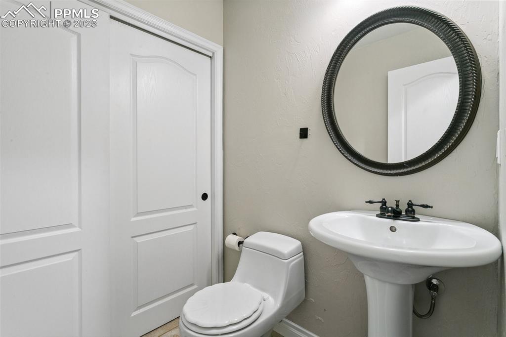 1502 York Road, Unit 103 Colorado Springs, CO 80920 - Photo 24 of 27 a bathroom with a sink a toilet and a mirror