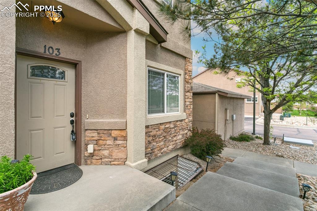 1502 York Road, Unit 103 Colorado Springs, CO 80920 - Photo 3 of 27 front view of a house with a yard