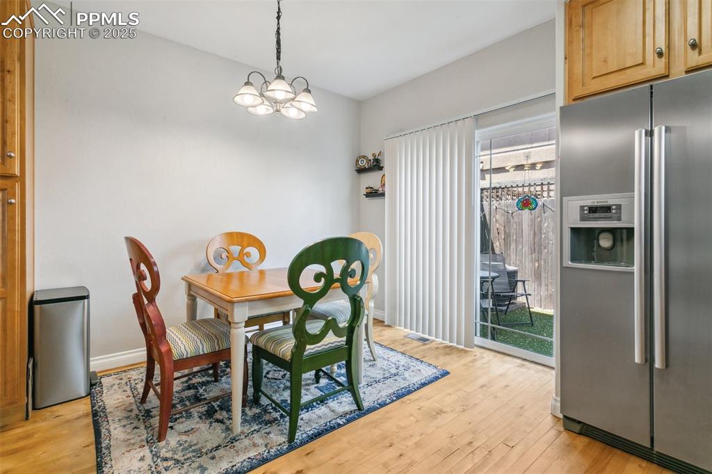 1502 York Road, Unit 103 Colorado Springs, CO 80920 - Photo 7 of 27 a view of a dining room with furniture and wooden floor