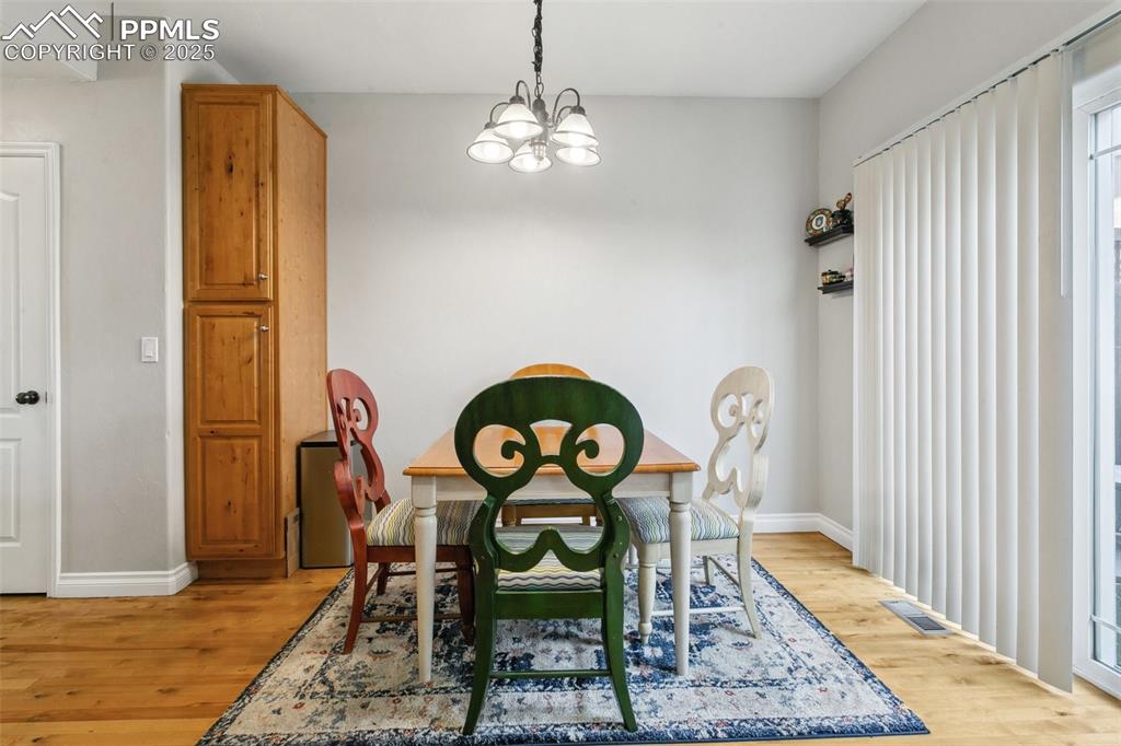 1502 York Road, Unit 103 Colorado Springs, CO 80920 - Photo 8 of 27 a view of a dining room with furniture and wooden floor