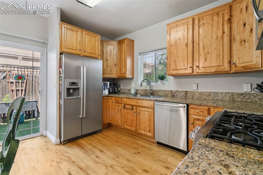 1502 York Road, Unit 103 Colorado Springs, CO 80920 - Photo 10 of 27 a kitchen with stainless steel appliances granite countertop a refrigerator and a sink