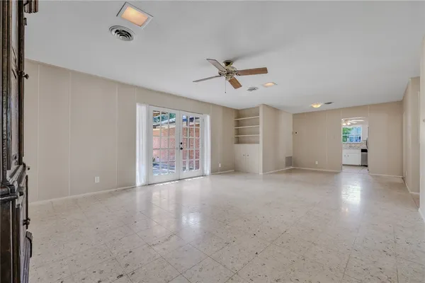 a kitchen with granite countertop white cabinets white appliances with a sink and a window