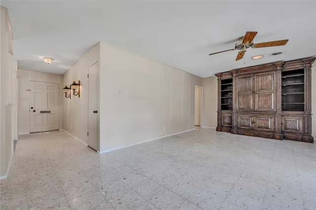 a kitchen with white cabinets and appliances