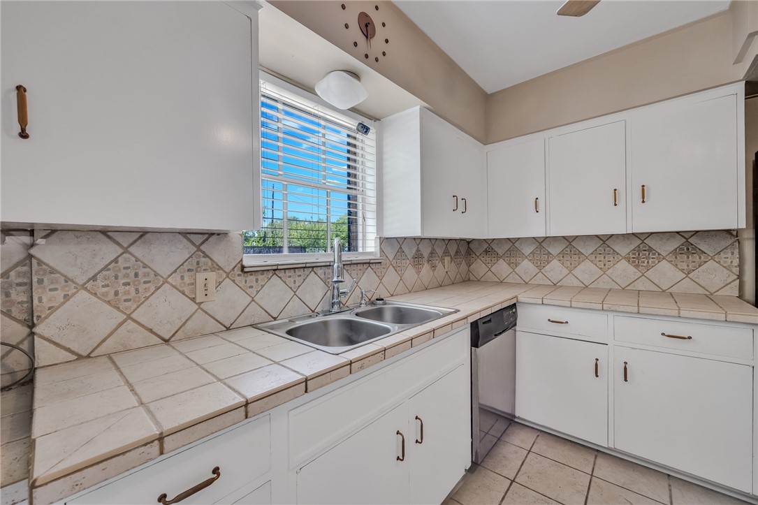 3401 Floyd Street Corpus Christi, TX 78411 - Photo 16 of 39 a kitchen with white cabinets and window