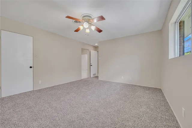 a view of an empty room with a bathroom