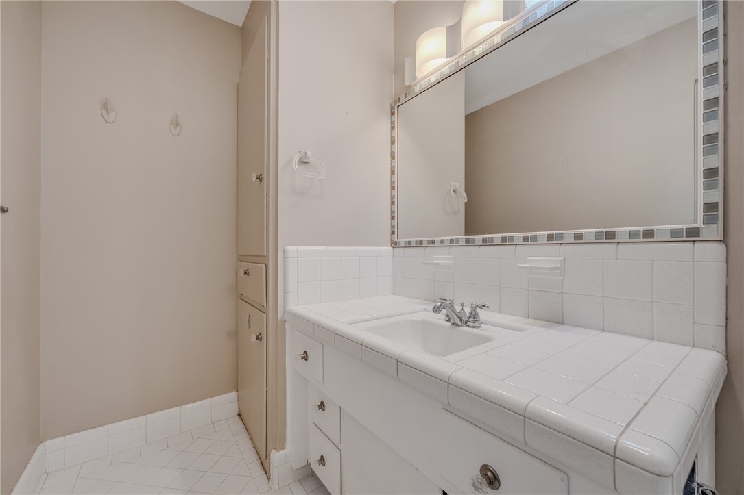3401 Floyd Street Corpus Christi, TX 78411 - Photo 24 of 39 a bathroom with a sink and a mirror