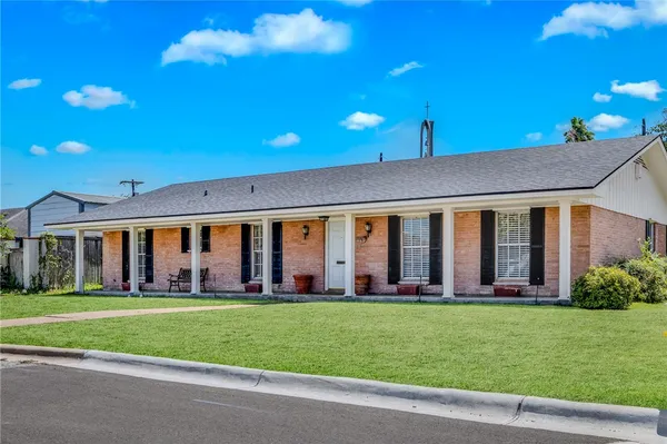 a front view of building with yard and green space