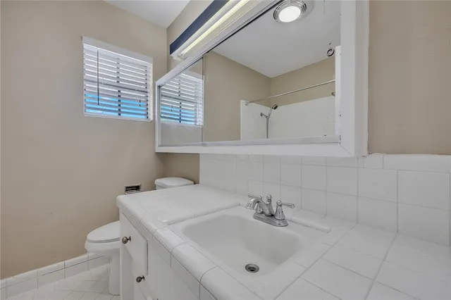 a view of an empty room with a chandelier fan