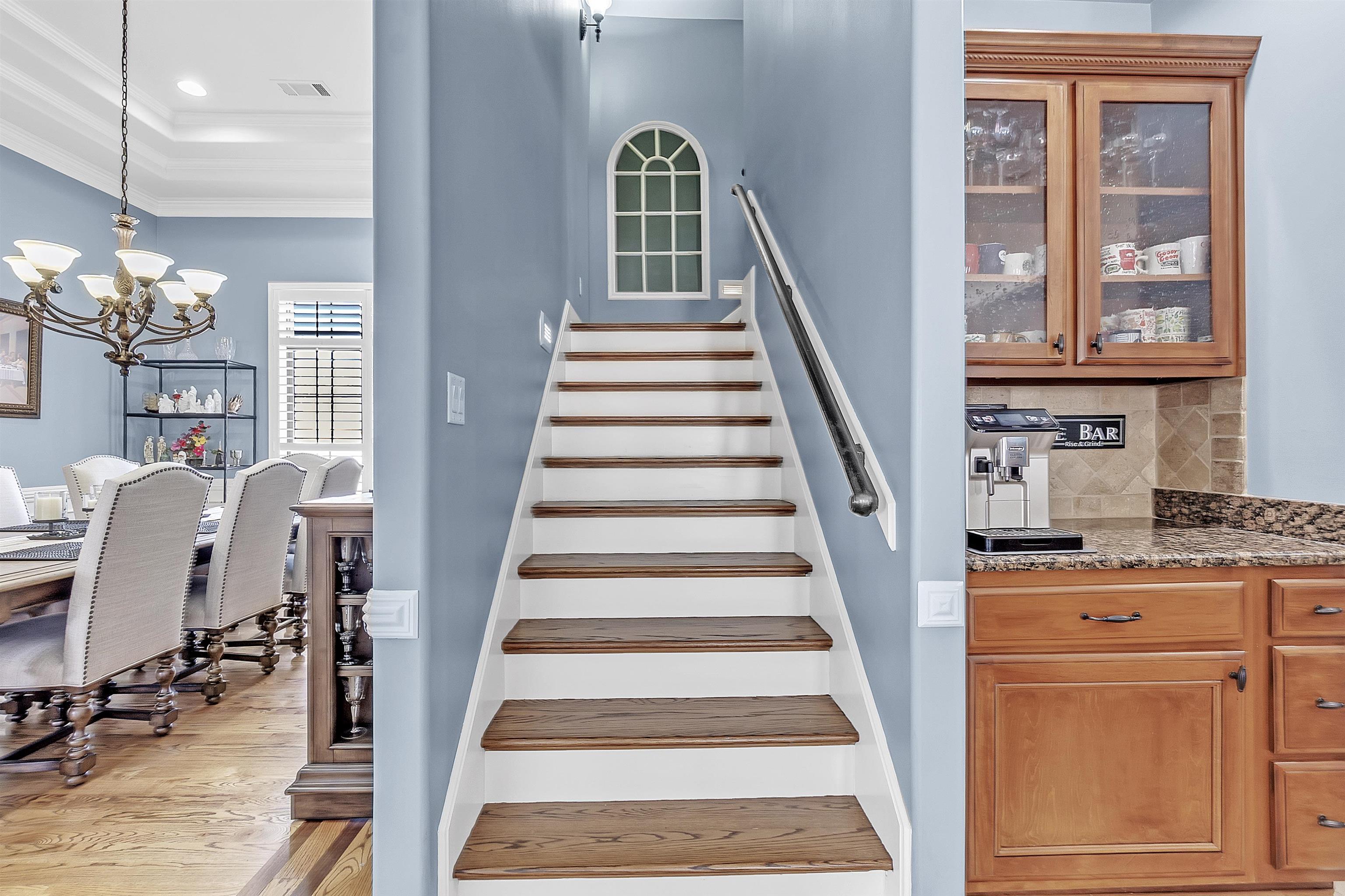 200 Misty Fields Road Oakland, TN 38060 - Photo 27 of 40 Stairs featuring crown molding, wood finished floors, a chandelier, and a raised ceiling