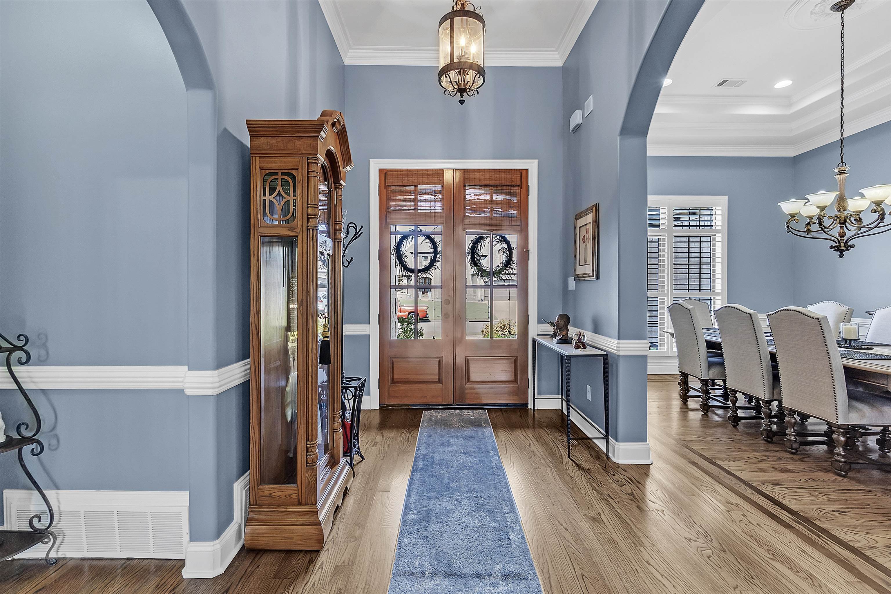 200 Misty Fields Road Oakland, TN 38060 - Photo 5 of 40 Entryway featuring a chandelier, arched walkways, wood finished floors, ornamental molding, and french doors