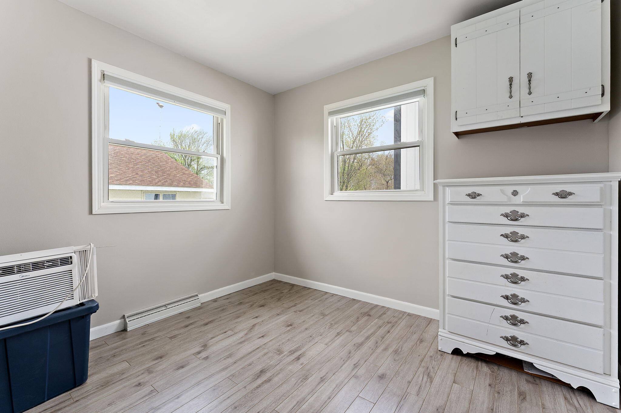 5590 East Maple Street Knox, IN 46534 - Photo 18 of 32 a view of an empty room with a window and wooden floor