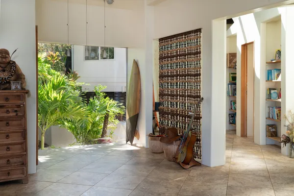 a backyard of a house with potted plants