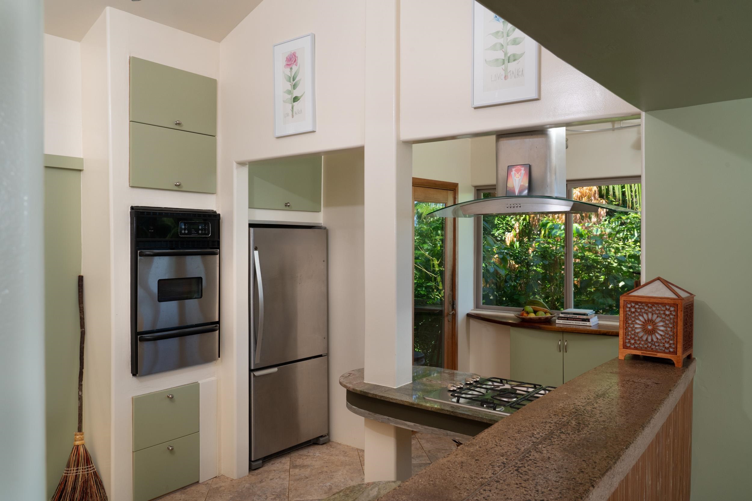 715 North Honokala Road Haiku, HI 96708 - Photo 21 of 50 a kitchen with stainless steel appliances granite countertop a refrigerator and a stove