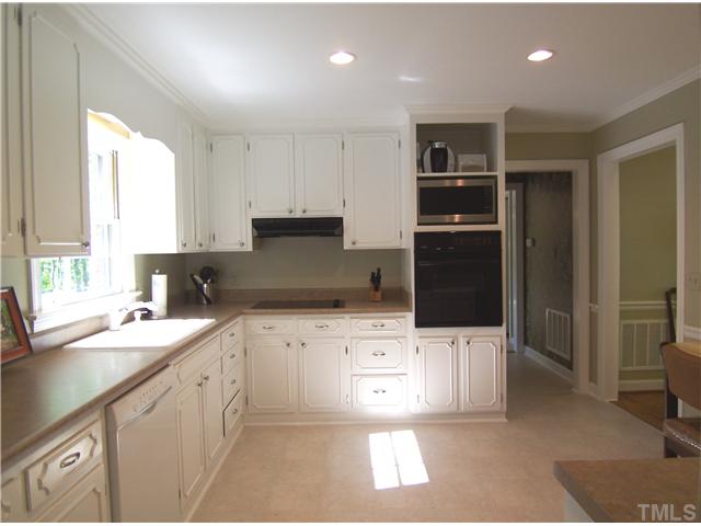 4920 Brookhurst Place Raleigh, NC 27609 - Photo 12 of 24 a kitchen with a sink a stove and refrigerator