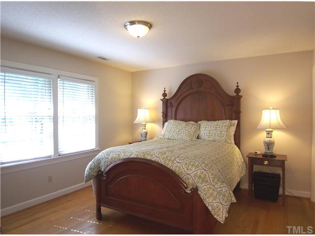 4920 Brookhurst Place Raleigh, NC 27609 - Photo 13 of 24 a bedroom with a bed and a window